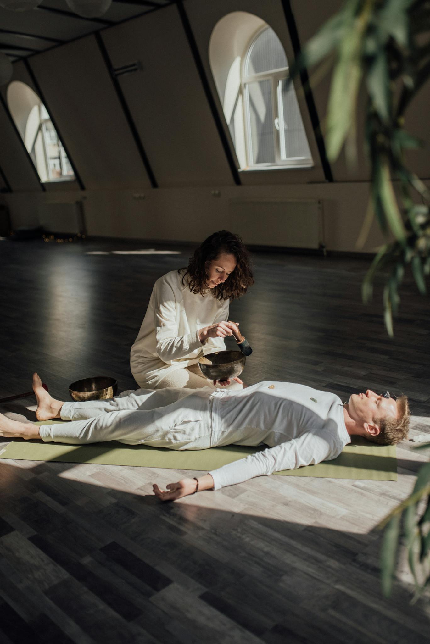 Serene indoor wellness session with a Tibetan singing bowl for relaxation and meditation.